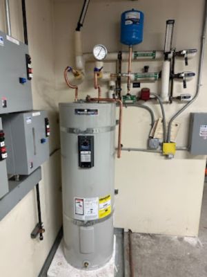 smart-plumbing-solutions-llc-00010 Residential water heater with manifold valves and pressure gauges mounted on wall