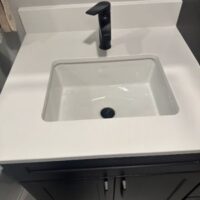 smart-plumbing-solutions-llc-00012 Modern bathroom vanity with white rectangular undermount sink and black faucet
