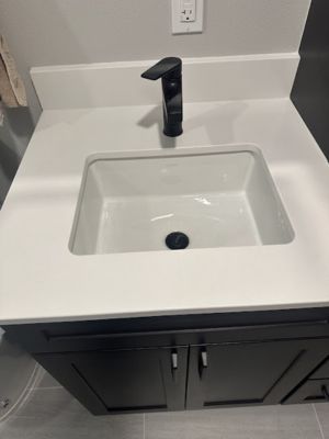 smart-plumbing-solutions-llc-00012 Modern bathroom vanity with white rectangular undermount sink and black faucet